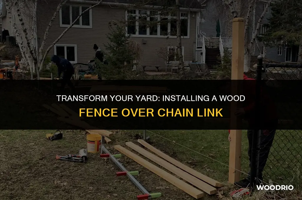 how to install a wood fence over a chain fence