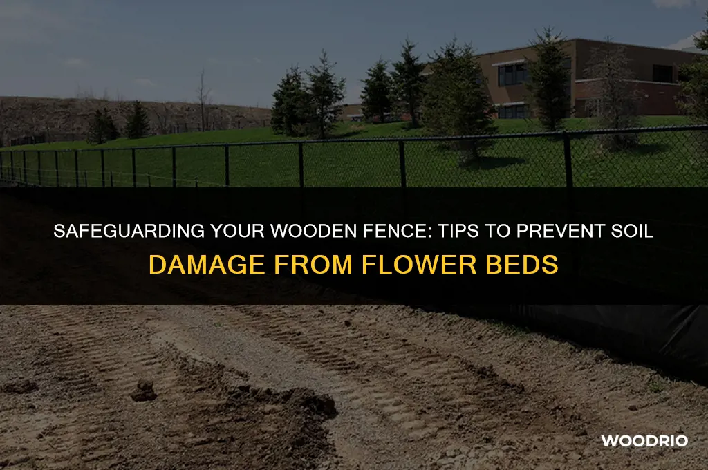 how to protect a wooden fence from flower bed soil