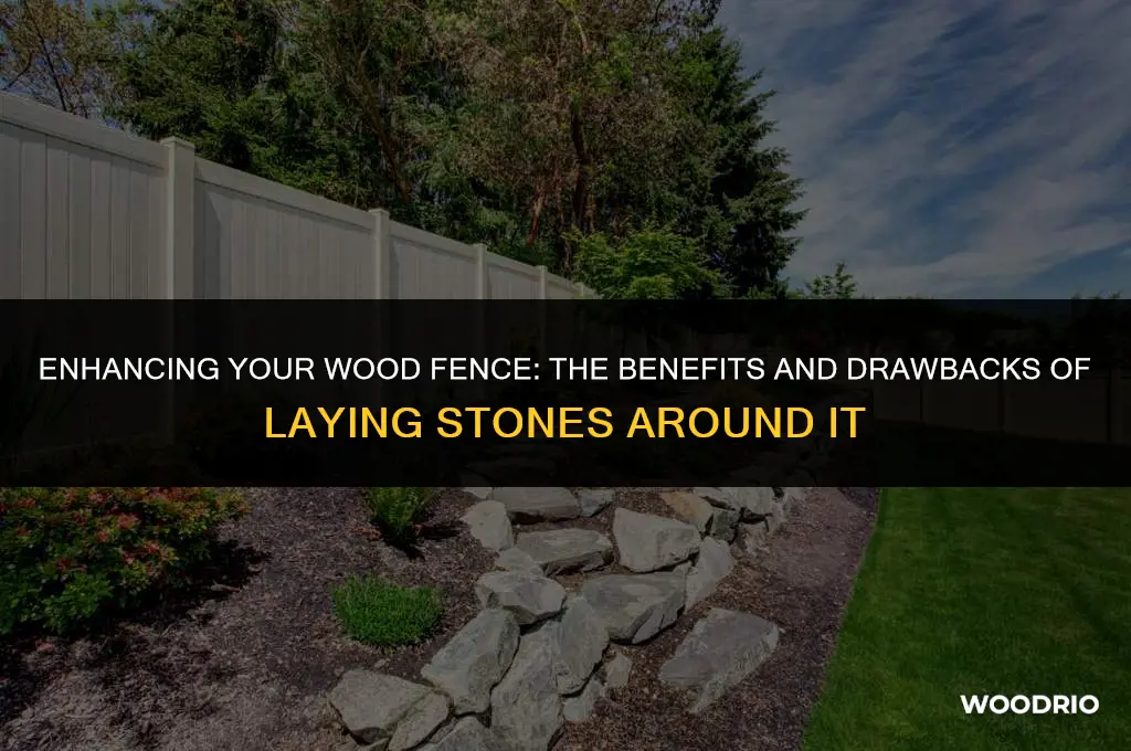 should i lay stones around wood fence